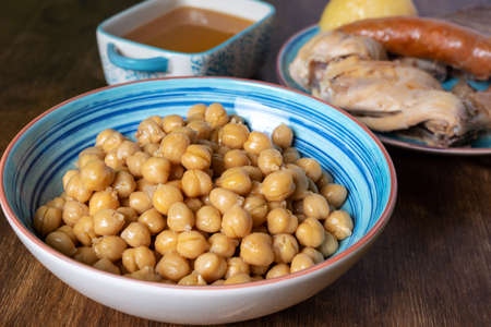 Cocido MadrileÃ±o, stew of chickpeas, vegetables, beef, chicken, chorizo and bacon typical of Madrid, served in separate dishes, soup, chickpeas and meat.の写真素材