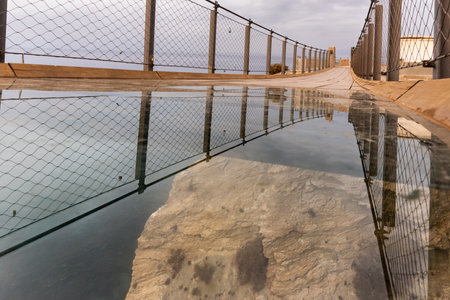Jolucar suspension footbridge, Torrenueva Costa, Granada, view of the drop into the void through the glass on the floor.の写真素材