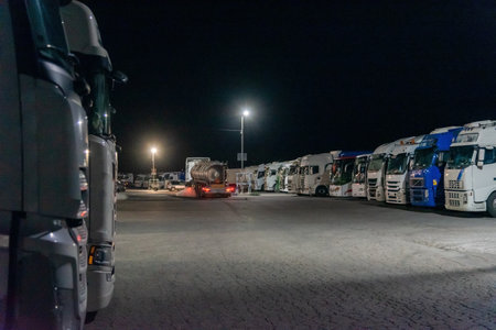 Truckers sleeping in a public parking lot completely full of a restaurant, and a truck that starts the marchの写真素材