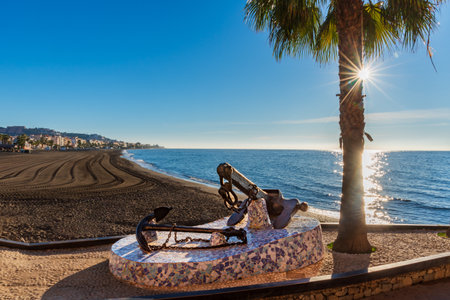 Rincon de la Victoria beach in Malaga, with a monument with ship anchors on the promenade in memory of its seafaring past. foreground.の写真素材
