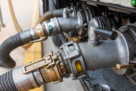 Devices attached to the mouths of a tanker truck to connect the discharge hoses, discharging diesel and gasoline.の写真素材