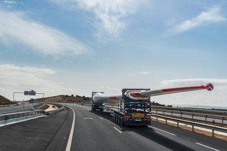 Special transport with a wind turbine blade driving on a highway.の写真素材