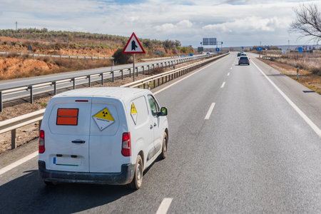 Van with orange plates of dangerous goods and with danger tags by radioactivity.の写真素材