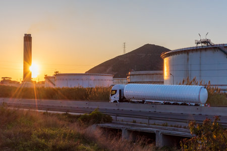 Cistern truck for the transport of cryogenic dangerous gases circulating along a road with large deposits of a refinery.の写真素材