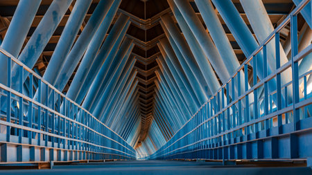 View of the lower part of a metallic construction bridge, where you can see the large tubes that hold the upper platform.の写真素材
