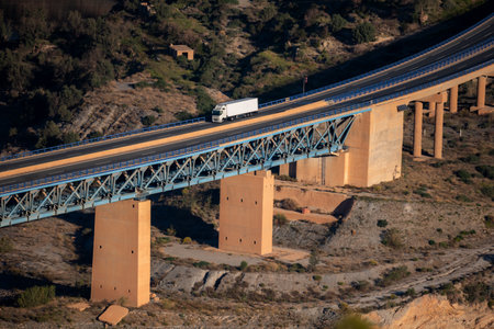 Refrigerated truck circulating on a highway on concrete and metal bridges.の写真素材