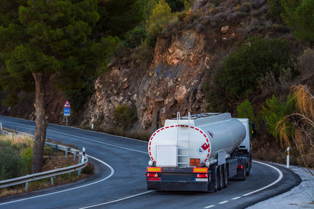 Fuel tanker truck driving on a mountain road.の写真素材