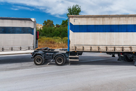Mega-trailer unhooking the rear trailer and being left alone with a small trailer.の写真素材
