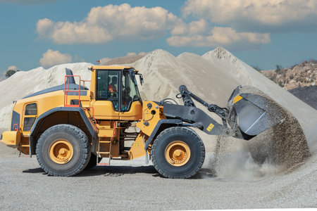 Wheel loaders moving sand in a quarry. Close-up.の写真素材