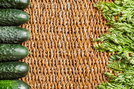 Background of braided cattail with cucumbers and herbs on the sides.の写真素材