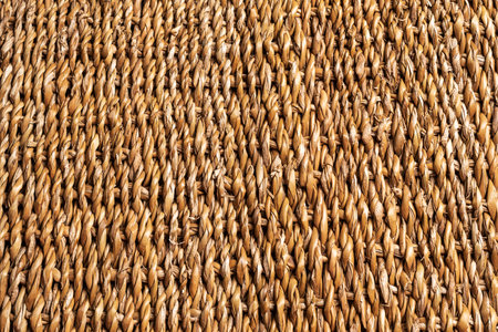Background or texture of braided cattail, brown color.