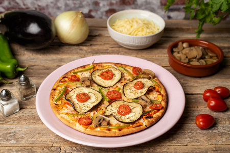 Vegetable pizza for vegetarians ready to eat, with eggplant, pepper, cherry tomato, onion and mushroom.の写真素材