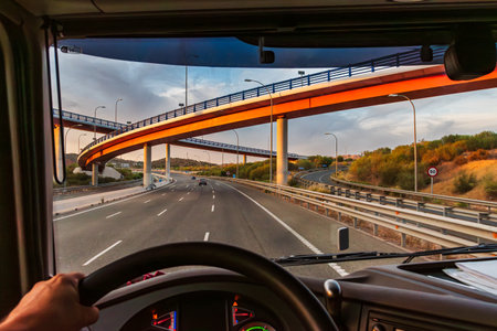 View from the driving position of a truck on a highway with several bridges at different levels.の写真素材