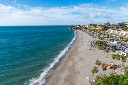 Burriana beach with the BalcÃ³n de Europa and part of the old town of Nerja in the background.の写真素材