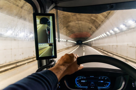 View from the driving position of a truck inside a highway tunnel and a screen as a rearview mirror.の写真素材
