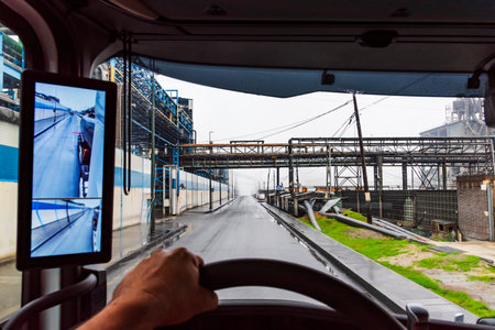 View from inside a truck of a street in an industrial estate, vehicle with rearview mirror for cameras.の写真素材