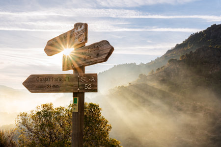 Indicator on the path that leads to the El Castillejo Site in Los Guajares, marking the town of...