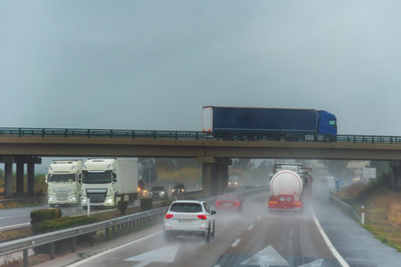 Highway with many cars and trucks circulating on a day of heavy rain.の写真素材
