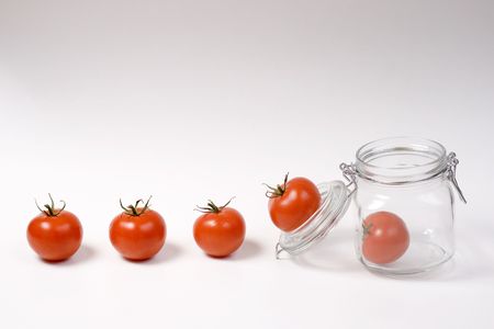 Happy tomatoes jumping in a jarの写真素材