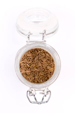 opened jar with spice isolated on whiteの写真素材