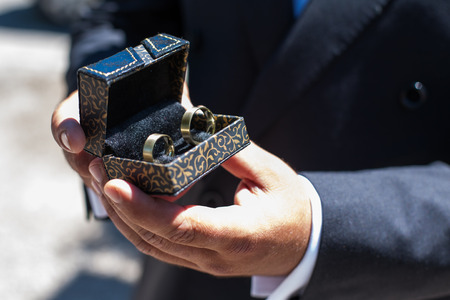 Close-up of a groom presentig the rings for the ceremony