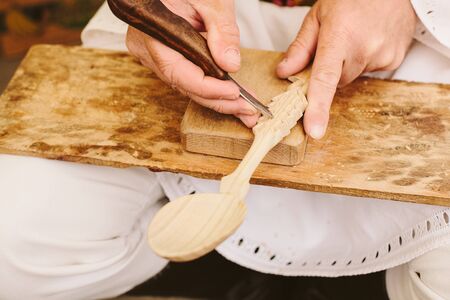 authentinc traditonal wood spoon carving sculpting romanian craftsmenの写真素材