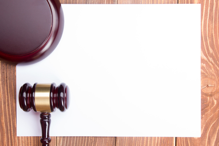 Law concept - Law book with a wooden judges gavel on table in a courtroom or law enforcement officeの写真素材