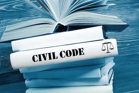 Law concept - Law book with Civil Code word on table in a courtroom or law enforcement office. Toned image.の写真素材