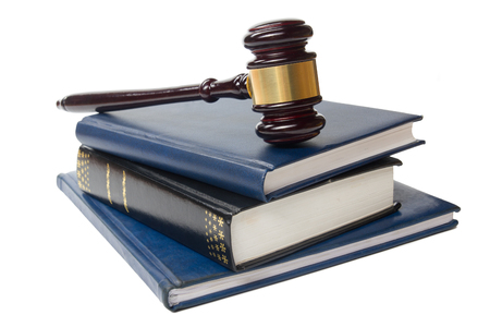 Law concept - Law book with a wooden judges gavel on table in a courtroom or law enforcement office isolated on white background. Copy space for text.の写真素材