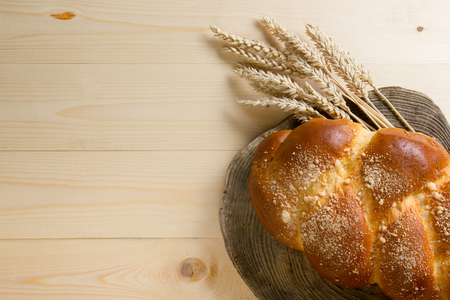 Fresh bread and wheat on the wooden table. Top view. Copy space.の写真素材