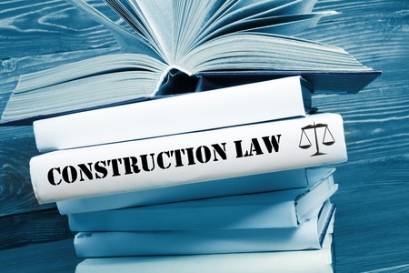 Law concept - Law book with Construction Law word on table in a courtroom or law enforcement office. Toned image.の写真素材
