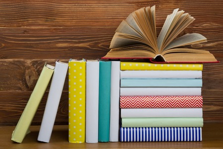 Open book, hardback books on wooden table. Back to school. Copy space.の写真素材