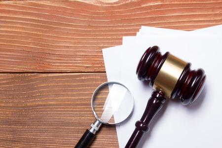 Law concept - Law book with a wooden judges gavel on table in a courtroom or law enforcement officeの写真素材
