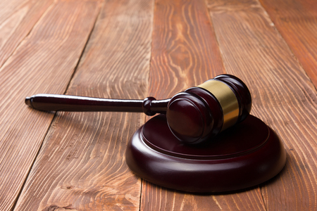 Law concept - Law book with a wooden judges gavel on table in a courtroom or law enforcement officeの写真素材