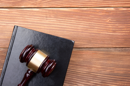 Law concept - Law book with a wooden judges gavel on table in a courtroom or law enforcement officeの写真素材