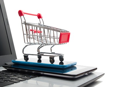 Online shopping concept - Empty Shopping Cart, laptop and tablet pc, smartphone isolated on white background. Copy space for textの写真素材