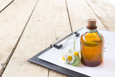 Fresh herb and medical clipboard on wooden table. Alternative medicine conceptの写真素材