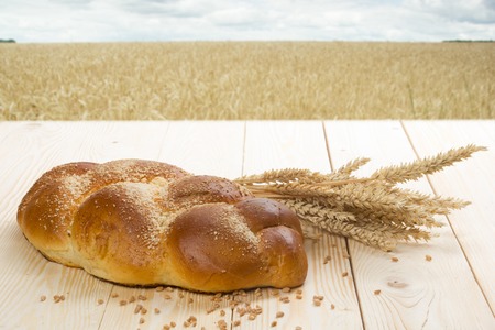 Fresh bread and wheat on the wooden table. Top view. Copy space.の写真素材