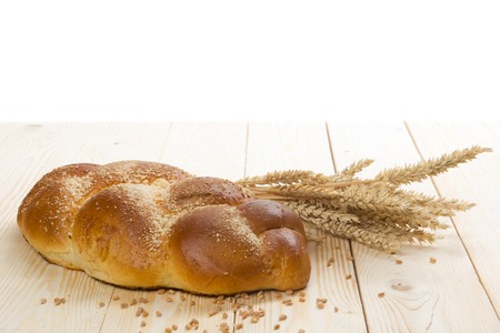Fresh bread and wheat on the wooden table. Top view. Copy space.の写真素材