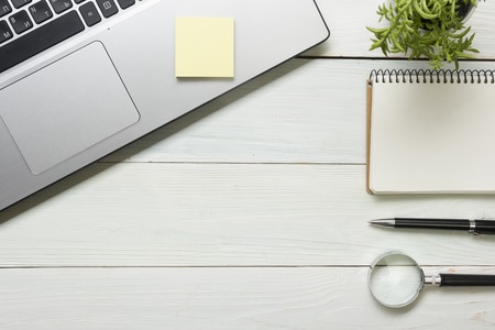 Office desk table with supplies and coffee cup. Top view. Copy space for text.の写真素材