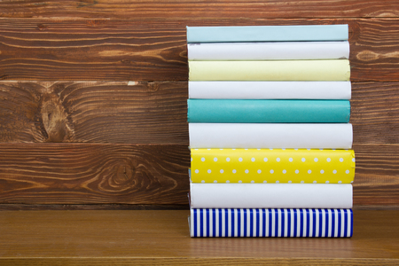 Stack of books on wooden table. Back to school. Copy space.の写真素材
