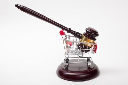 Judge gavel and shopping cart isolated on white background. Auction concept
