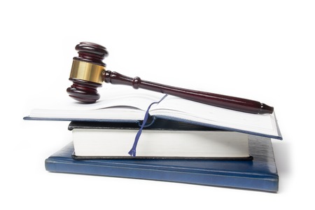 Law concept - Law book with a wooden judges gavel on table in a courtroom or law enforcement office isolated on white background. Copy space for text.の写真素材