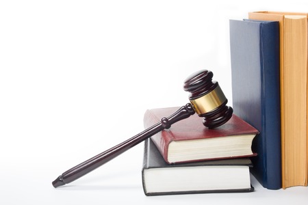 Law concept - Law book with a wooden judges gavel on table in a courtroom or law enforcement office isolated on white background. Copy space for text.の写真素材
