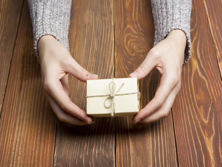 Present,  gift. Close up of female hands holding small gift.の写真素材