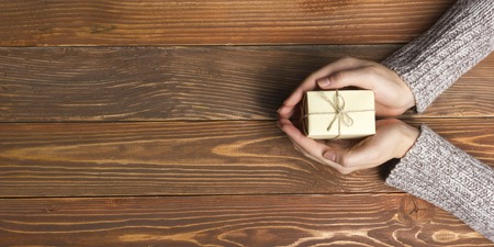 Present,  gift. Close up of female hands holding small gift.の写真素材