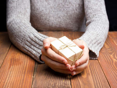 Present,  gift. Close up of female hands holding small gift.の写真素材
