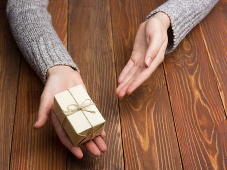 Present,  gift. Close up of female hands holding small gift.の写真素材