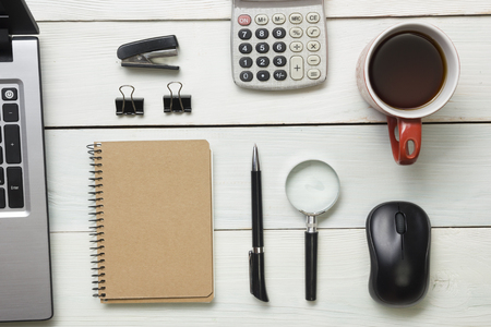 Office desk table with supplies and coffee cup. Top view. Copy space for text.の写真素材