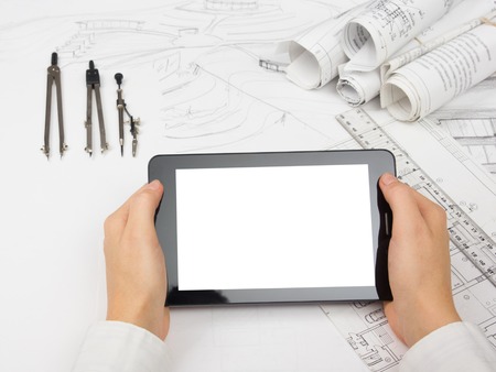 Architect working on blueprint. Architects workplace - architectural project, blueprints, ruler, calculator, laptop and divider compass. Construction concept. Engineering tools.の写真素材